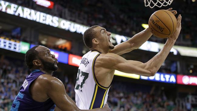 Charlotte Hornets centre Al Jefferson, left, fouls Utah Jazz centre Rudy Gobert.