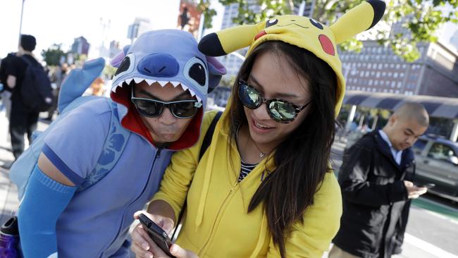 People costumed as the game's characters participate in a Pokemon Go search during a gathering of players in San Francisco. Picture: AP