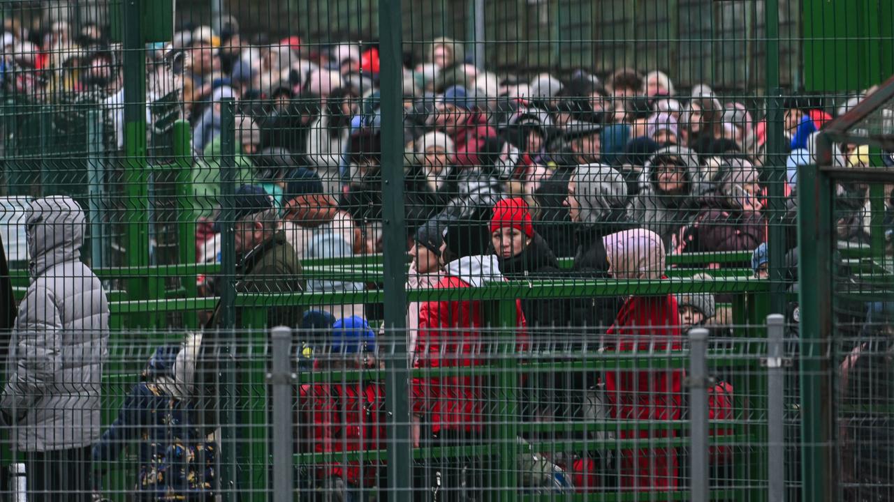 eople who fled the war in Ukraine wait in line for the passport control on the Ukrainian side at the Polish Ukrainian border. Picture: Omar Marques/Getty Images