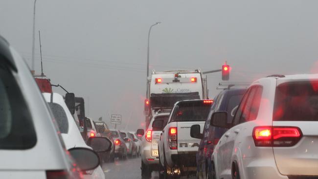 Traffic came to a standstill after a rental car rolled on wet Cairns highway. Picture: Brendan Radke