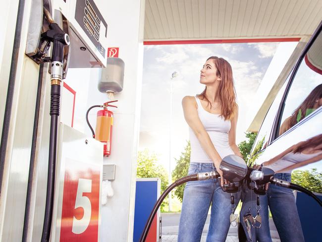 Pretty young woman filling her car with fuel at the petrol station. Picture: iStock