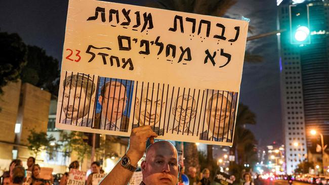 A sign showing the faces of Israeli politicians Bezalel Smotrich (Finance Minister), Simcha Rothman (chair of the parliament's Constitution, Law and Justice Committee), Benjamin Netanyahu (Prime Minister), Yariv Levin (Justice Minister), and Itamar Ben-Gvir (National Security Minister) behind black bars, during a protest in Tel Aviv. Picture: Ahmad Gharabli / AFP