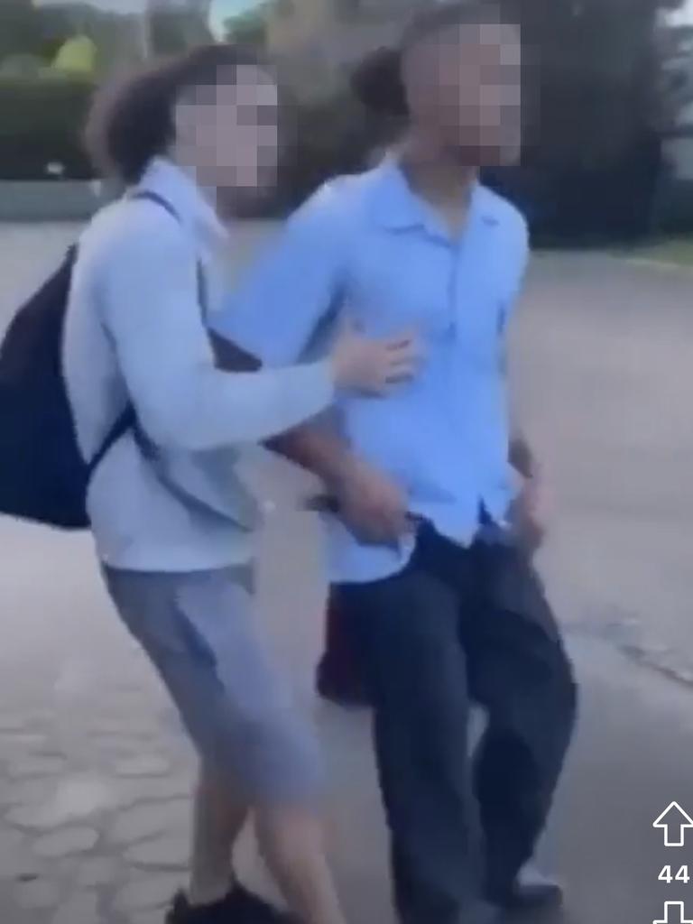 A youth armed with a knife is held back by a friend, as the two groups square off. Picture: Supplied