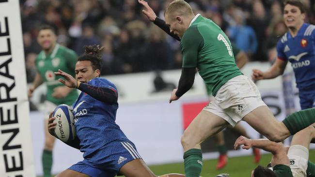 France winger Teddy Thomas runs to score a try at the Stade de France in Paris.