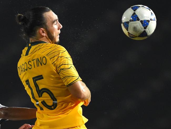 Australia's Nicholas D'Agostino (C) fights for the ball with Cambodia's Tes Sambath (2nd R) during the Tokyo 2020 Olympic Games men's Asian qualifier football match between Cambodia and Australia in Phnom Penh, on March 22, 2019. (Photo by TANG CHHIN Sothy / AFP)