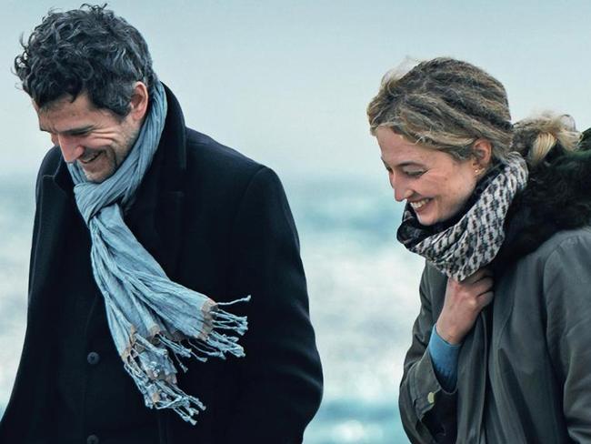 Laurent (Guillaume Canet) and Alice (Alba Rohrwacher) walk on the beach in Out of Season.