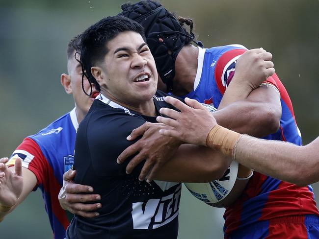 Jeremiah Leatigaga is wrapped up by the Newcastle defence. Picture: Michael Gorton