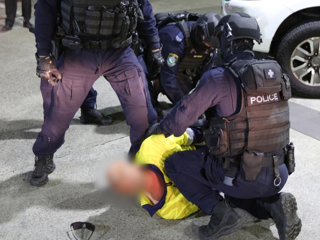 Fixated Persons Investigations Unit arrest pair over alleged car bombing and intimidation in Warrawong. Picture: NSW Police