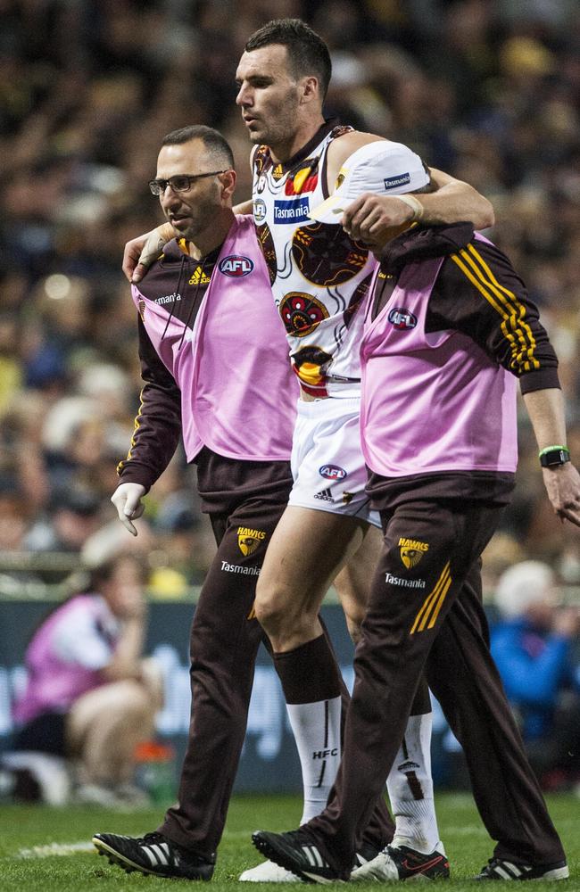 Jonathon Ceglar is helped off the ground after hurting his knee. Picture: AAP