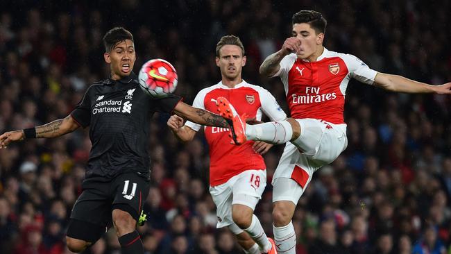 Arsenal's Spanish defender Hector Bellerin (R) kicks the ball away from Liverpool's Roberto Firmino.