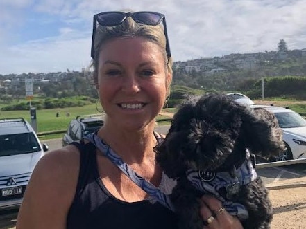 Dog owner, and TV presenter, Rozz Switzer, of Allambie Heights, with her cavoodle, Bullet, at the North Curl Curl off-leash dog park on Tuesday, reckons the council should continue providing free waste bags to ratepayers. Picture: Jim O’Rourke