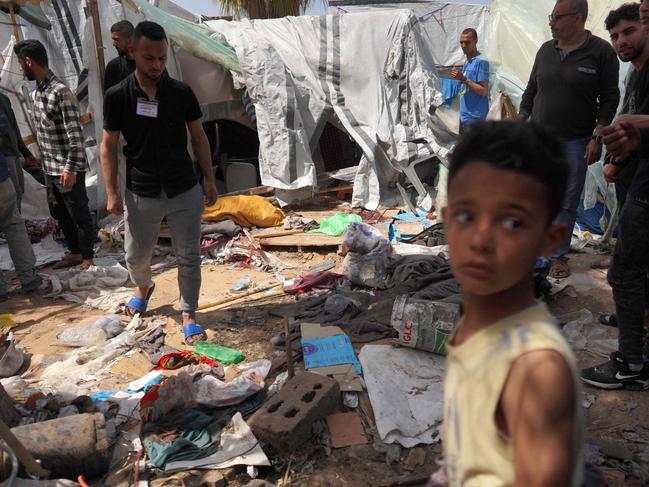 Palestinians check the damage at a makeshift camp for displaced people in front of the Al-Aqsa Martyrs Hospital in Deir al-Balah in the central Gaza Strip. Picture: AFP