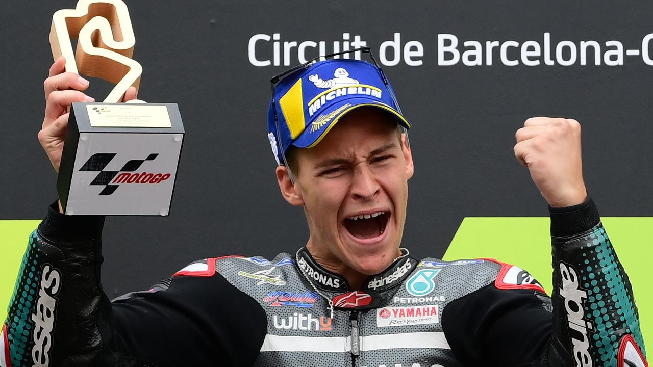 TOPSHOT - Petronas Yamaha SRT's French rider Fabio Quartararo celebrates on the podium after winning the MotoGP race of the Moto Grand Prix de Catalunya at the Circuit de Catalunya on September 27, 2020 in Montmelo on the outskirts of Barcelona. (Photo by LLUIS GENE / AFP)