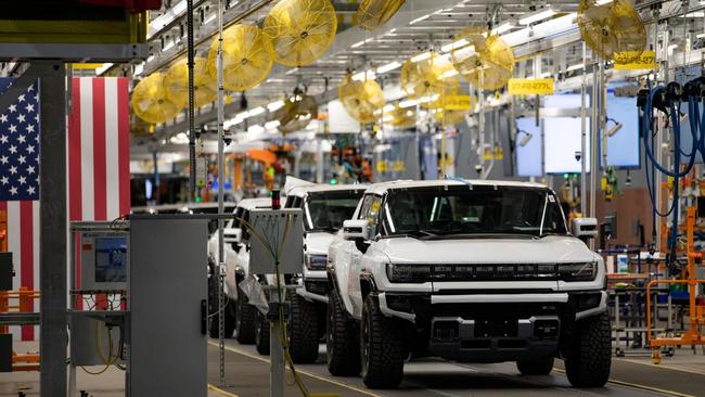 The US motor industry is fighting back against upstart Tesla in the race to produce electric vehicles. General Motors and Ford are both launching new all-electric models, including these GM Hummers being produced at its Factory ZERO assembly plant in Detroit. Picture: Emily Elconin / Bloomberg