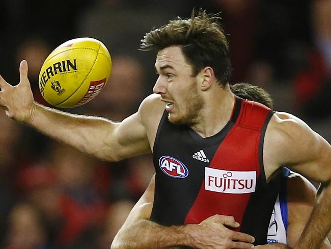 AFL Round 16. North Melbourne vs Essendon at Etihad Stadium. Michael Hibberd under pressure . Pic: Michael Klein