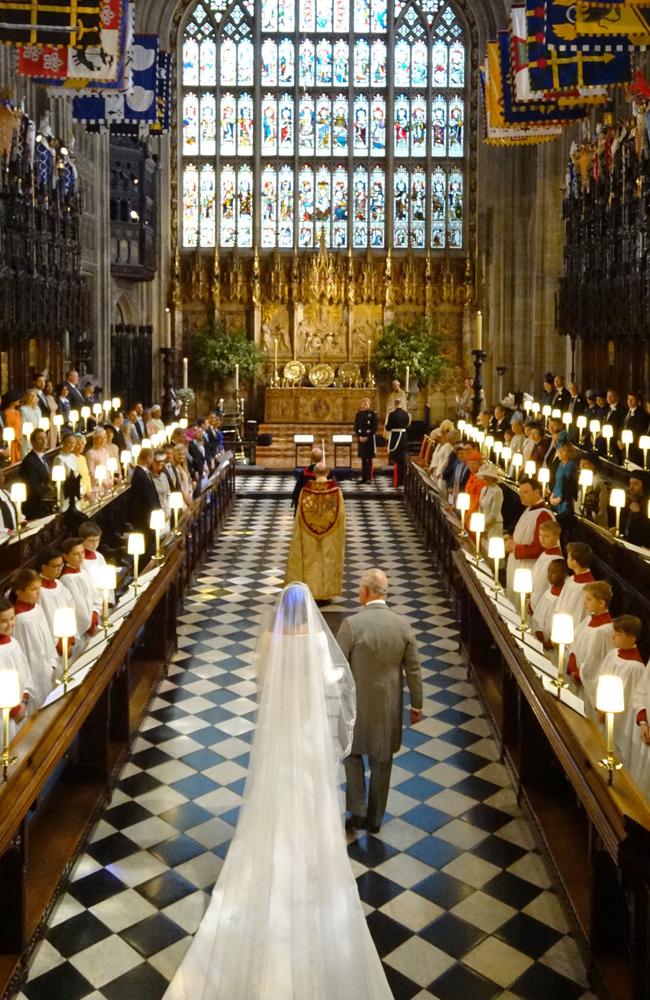 Britain's Prince Charles, Prince of Wales leads US fiancee of Britain's Prince Harry, Meghan Markle up the aisle of St George's Chapel for the wedding ceremony. Picture: Jonathan Brady/AFP