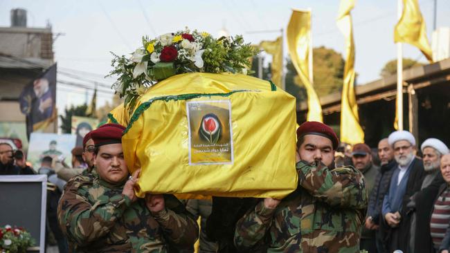 Members of Hezbollah alongside family members at the funeral of a person killed in Israeli strikes in Beirut.