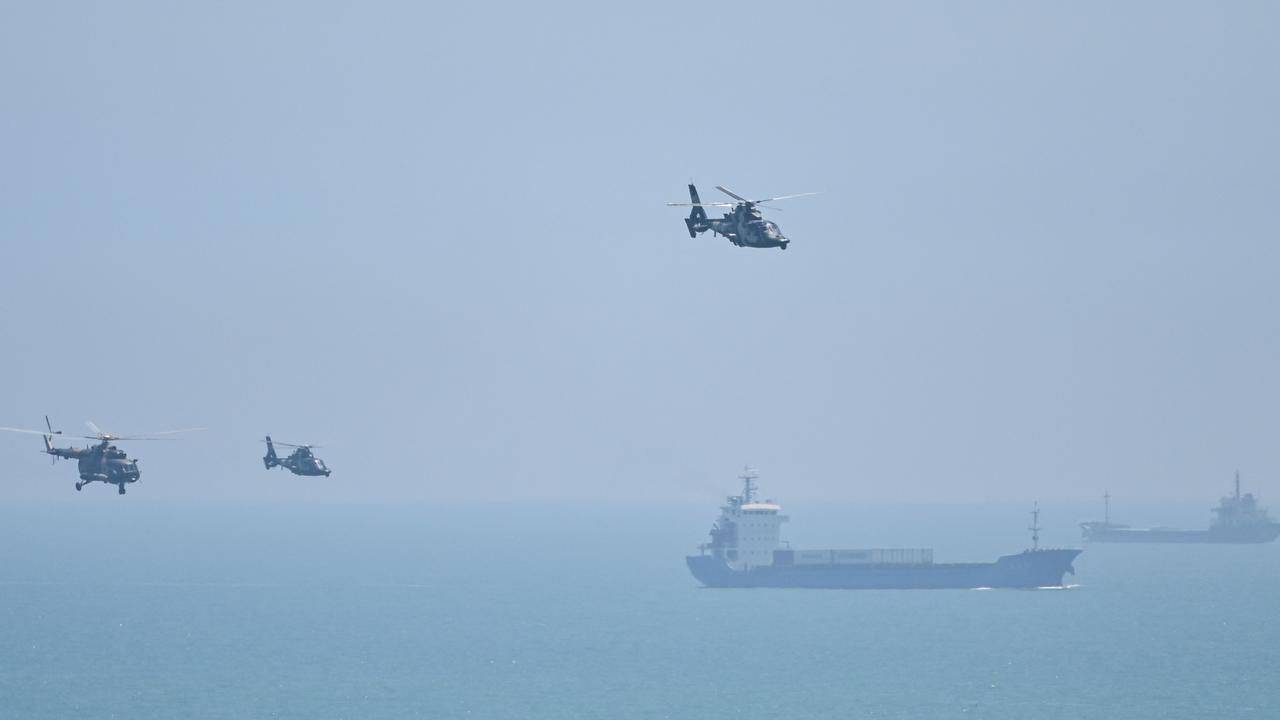 Chinese military helicopters fly past Pingtan Island, one of mainland China’s closest points from Taiwan. Picture: Hector Retamal/AFP