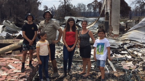 The Zagami family survey the damage on their Wairewa farm after the Black Summer bushfires.