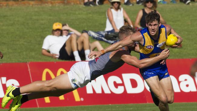 Jack Redden tries to break free from Port Adelaide’s Ollie Wines during the JLT Series. Picture: AAP Image/Tony McDonough