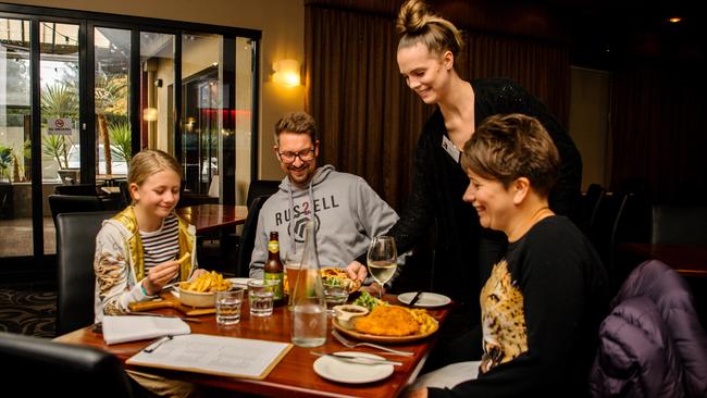 Amy Dreckow serves a celebratory meal to the Coshell family, Ophelia with parents Brett and Aldona at the Kensington Hotel. Picture: Morgan Sette