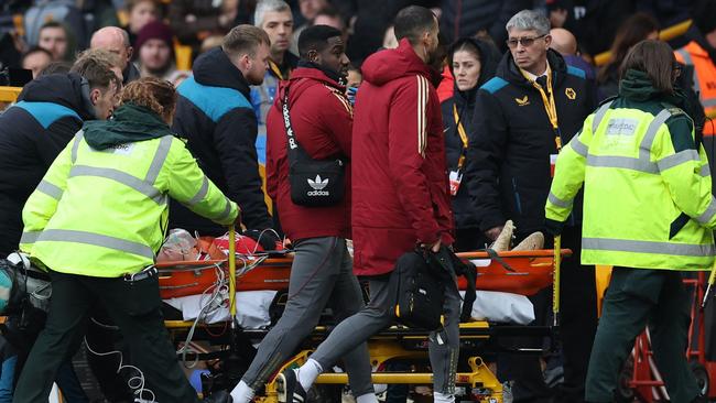 Maanum was taken from the field on a stretcher with oxygen. Photo by Adrian DENNIS / AFP