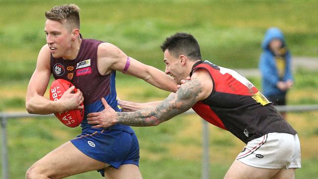 NFL: Banyule’s Reuben Blackmore-Moore tries to fend off Mikael Avramov. Picture: Hamish Blair