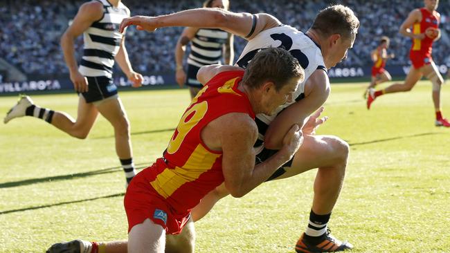 GEELONG, AUSTRALIA - MAY 22: Nick Holman of the Suns tackles Mitch Duncan of the Cats during the round 10 AFL match between the Geelong Cats and the Gold Coast Suns at GMHBA Stadium on May 22, 2021 in Geelong, Australia. (Photo by Darrian Traynor/AFL Photos/via Getty Images)