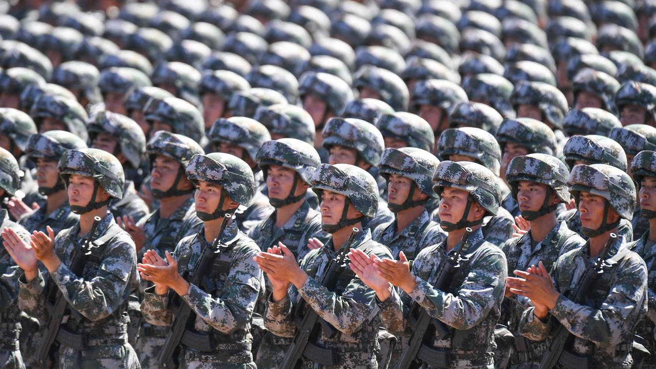 Chinese soldiers applauding during a military parade at the Zhurihe training base in China's northern Inner Mongolia region in 2017. Picture: AFP.