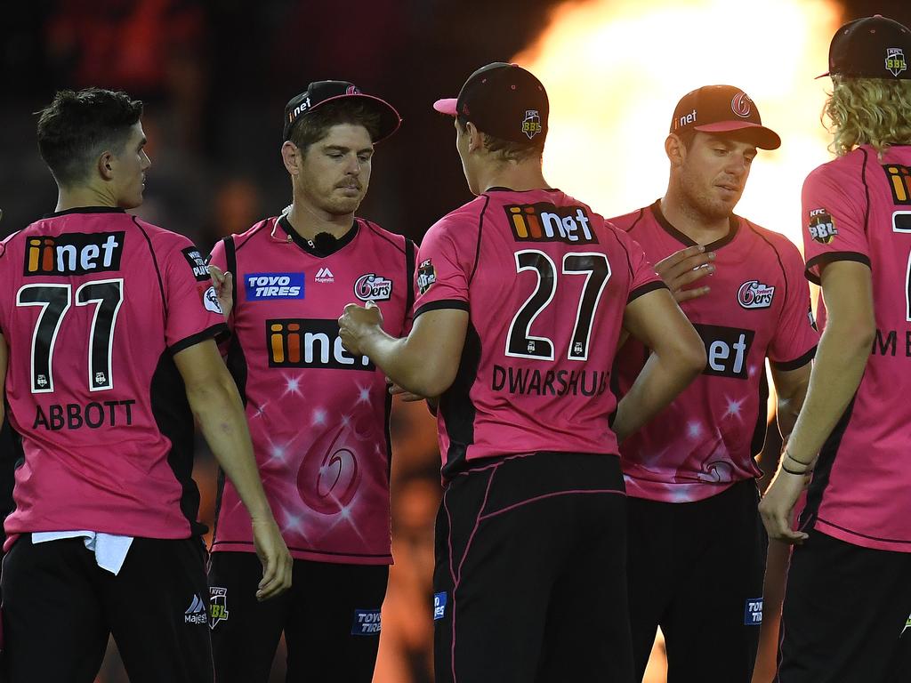 Sixers players commiserate after bowing out in a thriller to the Melbourne Renegades