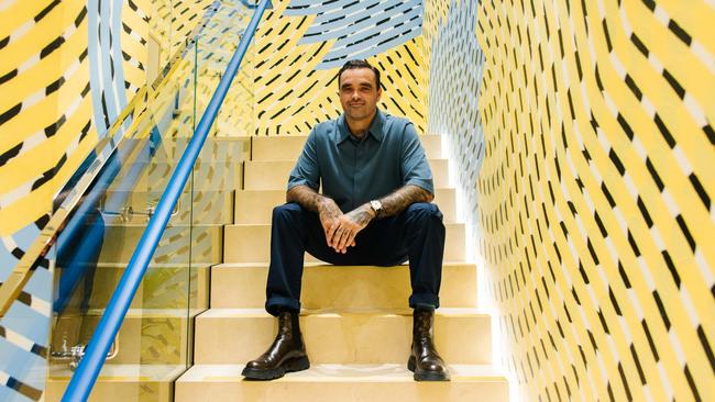 Artist Otis Hope Carey in front of his mural within Louis Vuitton latest flagship store. Picture: Louis Vuitton/Supplied