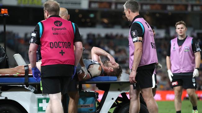 Trent McKenzie is taken from the ground after landing awkwardly. Picture: AFL Photos/via Getty Images