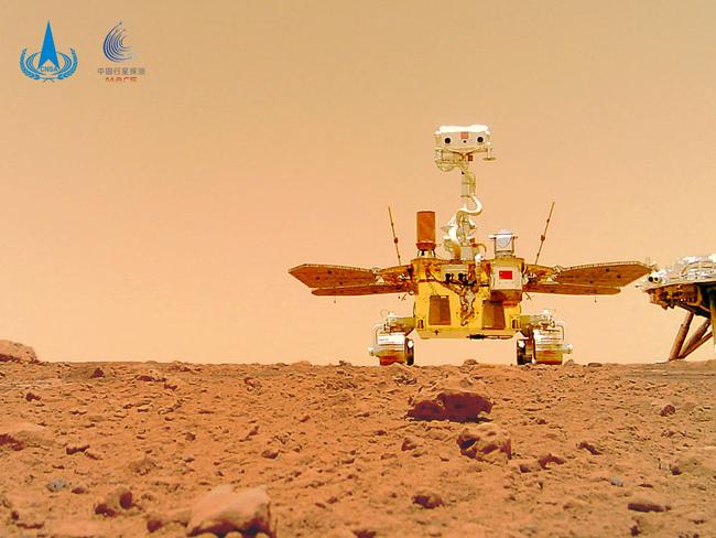 (FILES) This undated handout photograph released on June 11, 2021 by the China National Space Administration (CNSA) shows an image taken by a camera released from China's Zhurong Mars rover showing the rover (L) and the landing platform on the surface of Mars. A Chinese rover has found new evidence to support the theory that Mars was once home to a vast ocean, including tracing some ancient coastline where water may once have lapped, a study said on November 7, 2024. (Photo by HANDOUT / China National Space Administration (CNSA) / AFP) / -----EDITORS NOTE --- RESTRICTED TO EDITORIAL USE - MANDATORY CREDIT "AFP PHOTO / CNSA" - NO MARKETING - NO ADVERTISING CAMPAIGNS - DISTRIBUTED AS A SERVICE TO CLIENTS