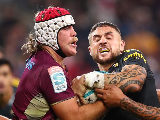 Queensland’s Fraser McReight (left) and the Hurricanes’ TJ Perenara battle for possession at AAMI Park. Picture: Kelly Defina/Getty Images