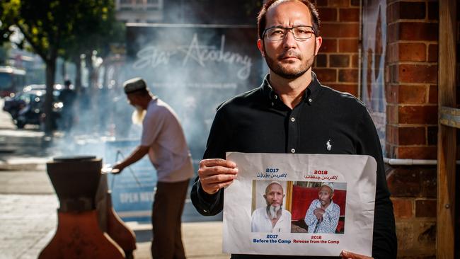 Adam Turan with a picture of his late father. Adam is in exile in Australia. His father was locked up in Xinjiang, and died shortly after his release. Picture: Matt Turner