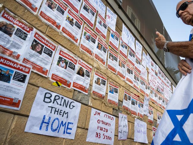 Fliers and signs with the names and faces of people kidnapped outside the Israeli Defence Ministry. Picture: Getty