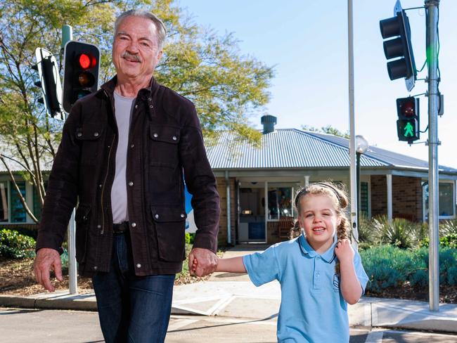 Daily Telegraph. 23, May, 2024.Jim Stafford, with his grandaughter, Maddison Crawford, 5, using the new crossing, at Karonga School, for kids with intellectual and physical disabilities, in Epping, today. It is the first school in NSW to install working traffic lights with a pedestrian crossing, in the middle of the school, to practice crossing safely.Picture: Justin Lloyd.