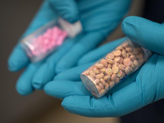 Jonathan Dumke, a senior forensic chemist with the Drug Enforcement Administration, holds vials of fentanyl pills at a DEA research laboratory on Tuesday, April 29, 2025, in Northern Virginia. (AP Photo/Mark Schiefelbein)