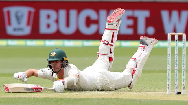 Pat Cummins dives for his crease on day two. Picture: AAP