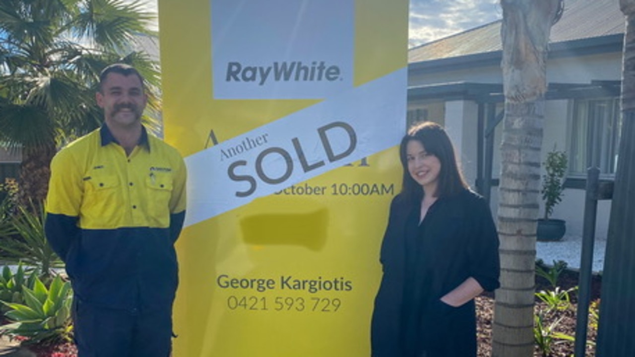 Toni and James in front of their first home. Picture: supplied