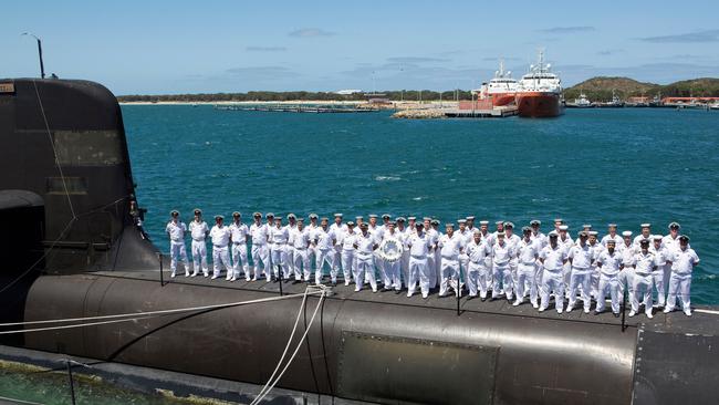 The crew stand on the casing of HMAS Sheean alongside Diamantina Pier, Fleet Base West. Thousands of Australians will need to be trained with the change to nuclear-powered submarines.