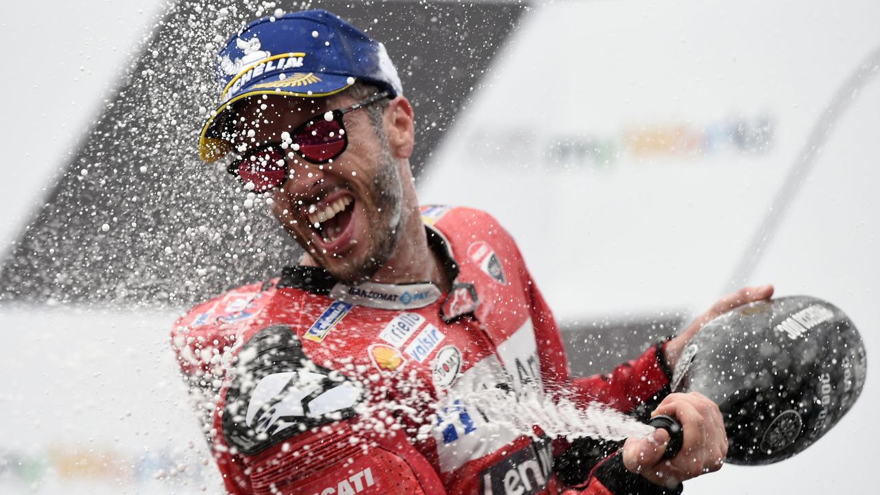 Andrea Dovizioso celebrates on the podium after winning the Austrian Grand Prix.
