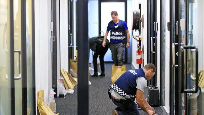 Police raid a diamond dealer on Collins St. Picture: Mark Stewart