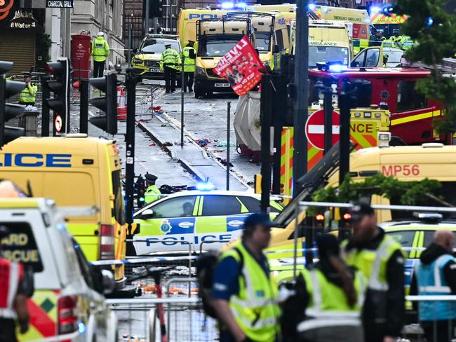 Ambulances and police vans arrive on the scene of an incident in Water Street, on the sidelines of an open-top bus victory parade for Liverpool's Premier League title win, in Liverpool, north-west England on May 26, 2025. (Photo by Paul ELLIS / AFP)