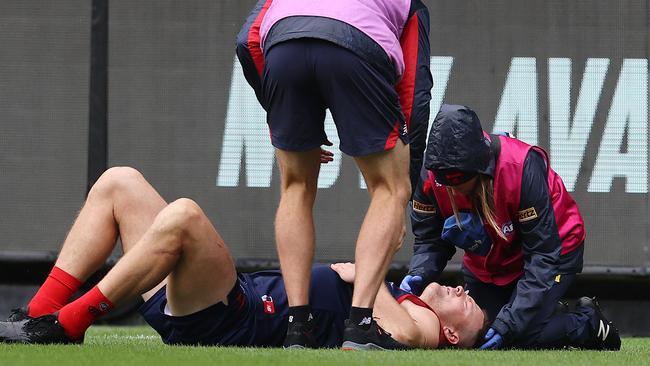 The Demons defender lies on the ground after colliding with Hawkins. Picture: Michael Klein