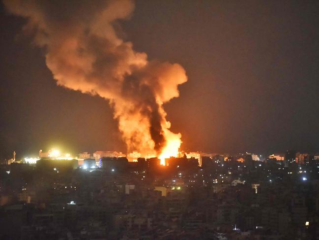 TOPSHOT - Fire and smoke rise at an area targeted by an Israeli airstrike on Beirutâs southern suburb on October 6, 2024. Official Lebanese media said five Israeli strikes hit south Beirut and its outskirts during the night of Octobre 5, 2024, four of them "very violent", after the Israeli army called residents to evacuate the Hezbollah bastion. (Photo by Fadel ITANI / AFP)