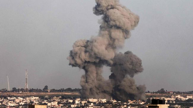 A smoke plume erupts over Khan Yunis from Rafah in the southern Gaza Strip during Israeli bombardment on December 26. Picture: Said Khatib/AFP