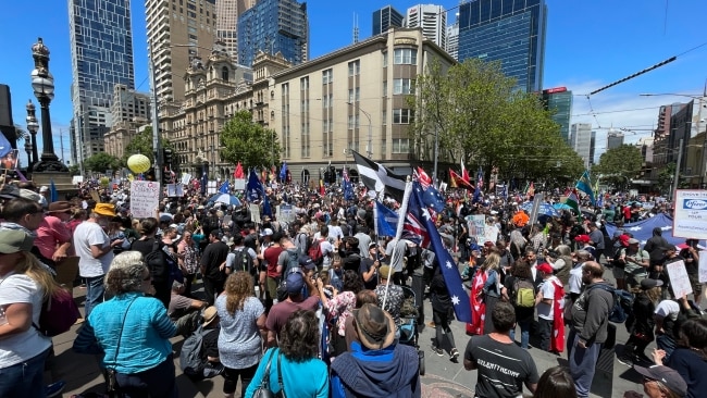 Groups can be seen waving a variety of banners including the Australian, Eureka and Red Ensign flags. Some are dancing and singing to music. Picture: Alex Coppel