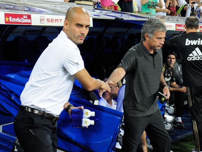 (FILES) This file photo taken on August 14, 2011 shows Barcelona's coach Josep Guardiola (L) and Real Madrid's Portuguese coach Jose Mourinho shaking hands before the Spanish Supercup first leg football match between Real Madrid and Barcelona at the Santiago Bernabeu stadium in Madrid. Manchester United welcome Manchester City to Old Trafford on September, 10, 2016, in a derby match that sees opposing managers Jose Mourinho and Pep Guardiola renew their sulphurous rivalry. / AFP PHOTO / DANI POZO