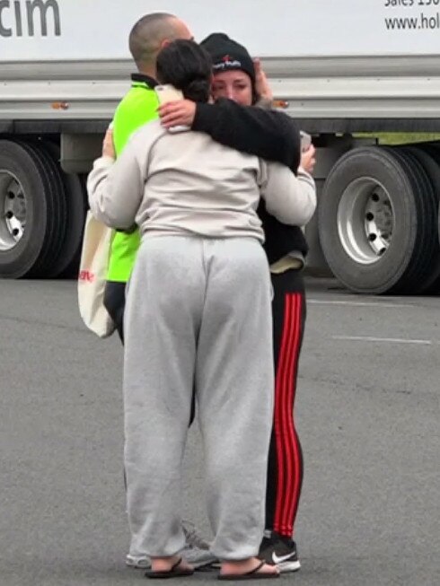 Distraught people hug at the scene. Picture: TNV